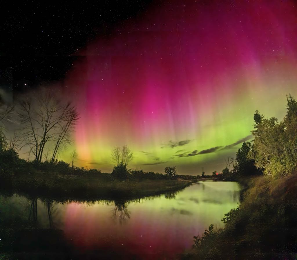 The Northern Lights dance on Lake Michigan's shore above the 45th Parallel. Photograph by Patrick Grubba. 